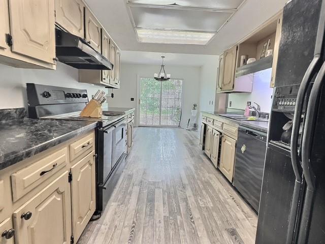 1024 E 12th St, Cushing, OK 74023 - kitchen featuring range with electric stovetop, black refrigerator with ice dispenser, under cabinet range hood, dishwashing machine, and light wood-style flooring
