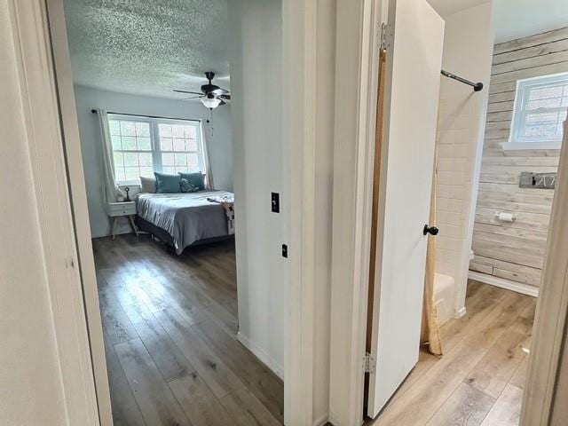 1024 E 12th St, Cushing, OK 74023 - hallway with light wood-type flooring and a textured ceiling