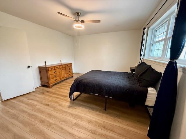 1024 E 12th St, Cushing, OK 74023 - bedroom featuring light wood-style floors and a ceiling fan