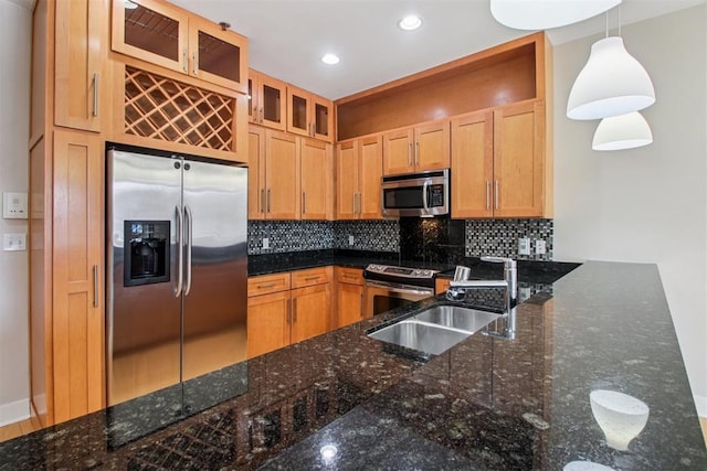 444 N Central Ave Unit 204, Oklahoma City, OK 73104 - kitchen featuring appliances with stainless steel finishes, backsplash, glass insert cabinets, hanging light fixtures, and dark stone countertops