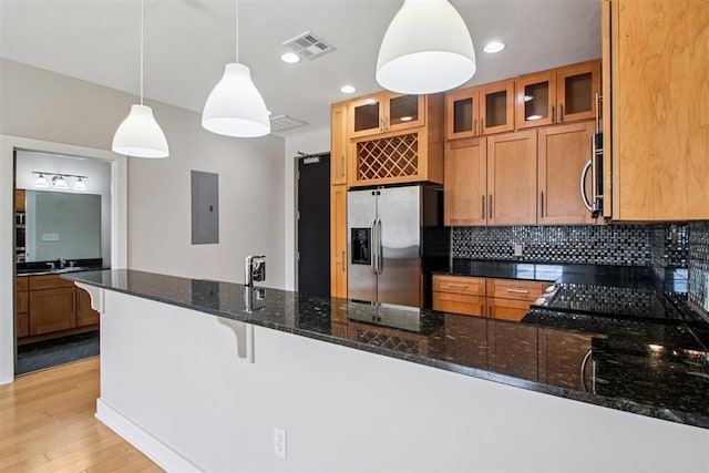 444 N Central Ave Unit 204, Oklahoma City, OK 73104 - kitchen featuring appliances with stainless steel finishes, electric panel, brown cabinets, a peninsula, and tasteful backsplash