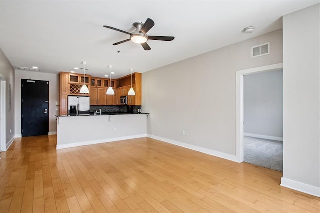 444 N Central Ave Unit 204, Oklahoma City, OK 73104 - unfurnished living room featuring a ceiling fan and light wood-style floors