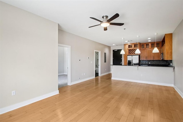 444 N Central Ave Unit 204, Oklahoma City, OK 73104 - unfurnished living room featuring ceiling fan and light wood-style floors