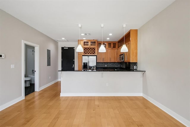 444 N Central Ave Unit 204, Oklahoma City, OK 73104 - kitchen featuring stainless steel appliances, a peninsula, dark countertops, tasteful backsplash, and recessed lighting
