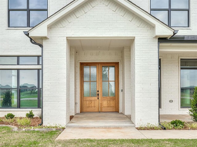 7431 NE Hawk Dr, Piedmont, OK 73078 - property entrance featuring brick siding and french doors