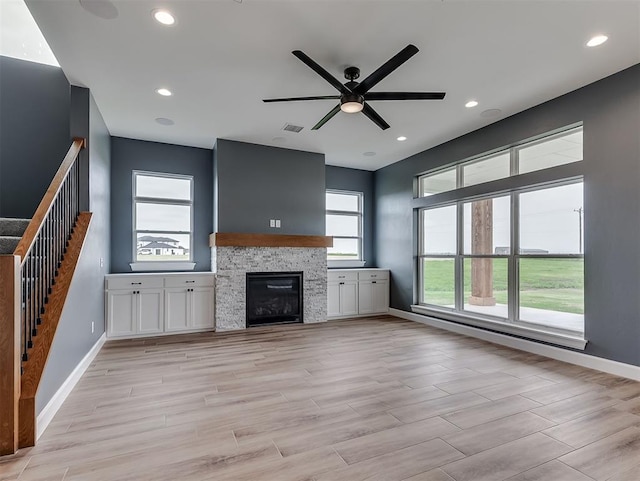 7431 NE Hawk Dr, Piedmont, OK 73078 - unfurnished living room featuring stairway, ceiling fan, a fireplace, light wood-style flooring, and recessed lighting