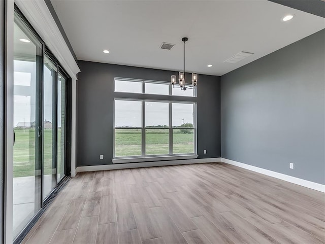 7431 NE Hawk Dr, Piedmont, OK 73078 - spare room featuring light wood finished floors, a chandelier, and recessed lighting