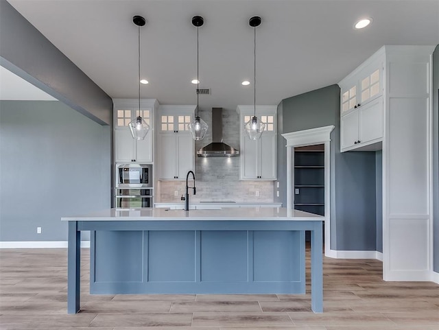 7431 NE Hawk Dr, Piedmont, OK 73078 - kitchen with wall chimney range hood, stainless steel oven, built in microwave, light countertops, and tasteful backsplash