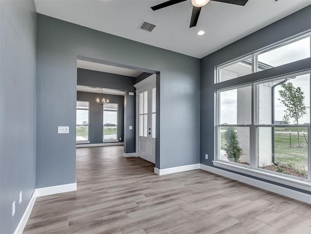 7431 NE Hawk Dr, Piedmont, OK 73078 - unfurnished room with plenty of natural light, a chandelier, ceiling fan, light wood-style floors, and recessed lighting