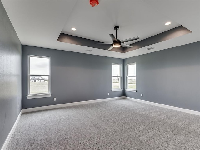 7431 NE Hawk Dr, Piedmont, OK 73078 - carpeted spare room with a raised ceiling, a ceiling fan, and recessed lighting
