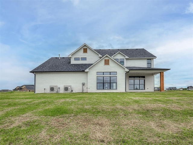 7431 NE Hawk Dr, Piedmont, OK 73078 - back of house with a lawn and a shingled roof