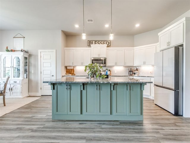 2315 Dixie Dr, Blanchard, OK 73010 - kitchen with appliances with stainless steel finishes, white cabinetry, light stone counters, decorative backsplash, and recessed lighting