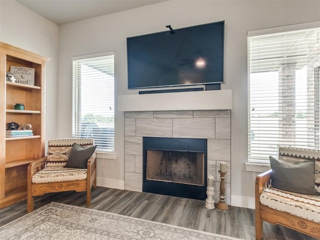2315 Dixie Dr, Blanchard, OK 73010 - sitting room featuring wood finished floors, a tile fireplace, and healthy amount of natural light