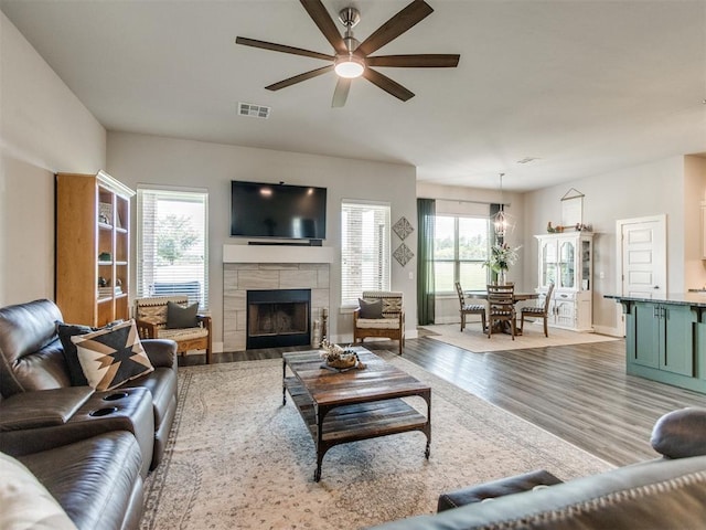 2315 Dixie Dr, Blanchard, OK 73010 - living area with ceiling fan, wood finished floors, and a tiled fireplace