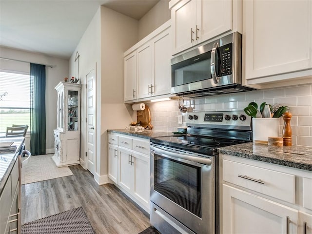 2315 Dixie Dr, Blanchard, OK 73010 - kitchen featuring appliances with stainless steel finishes, light wood-style flooring, dark stone counters, and tasteful backsplash