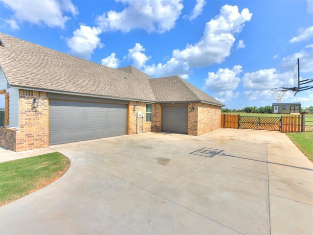 2315 Dixie Dr, Blanchard, OK 73010 - view of front of house featuring brick siding, concrete driveway, an attached garage, and a shingled roof