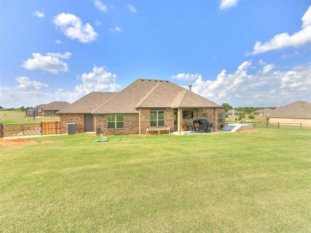 2315 Dixie Dr, Blanchard, OK 73010 - back of house featuring roof with shingles, a patio area, and brick siding