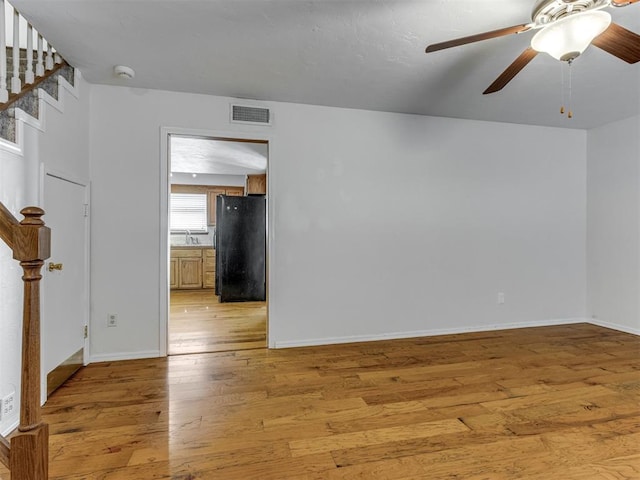 1800 Michael Dr, Edmond, OK 73013 - spare room with light wood-style flooring, a smoke detector, stairs, and a ceiling fan