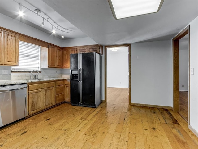 1800 Michael Dr, Edmond, OK 73013 - kitchen with black refrigerator with ice dispenser, stainless steel dishwasher, light wood-style floors, brown cabinets, and rail lighting