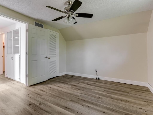 1800 Michael Dr, Edmond, OK 73013 - bonus room featuring ceiling fan, wood finished floors, a textured ceiling, and vaulted ceiling
