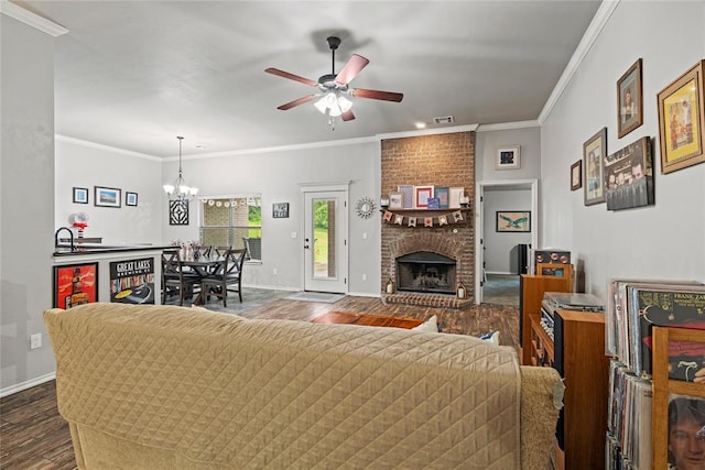 7324 Ridge Manor Ln, Oklahoma City, OK 73150 - living area with dark wood-style flooring, ceiling fan, a brick fireplace, a chandelier, and ornamental molding