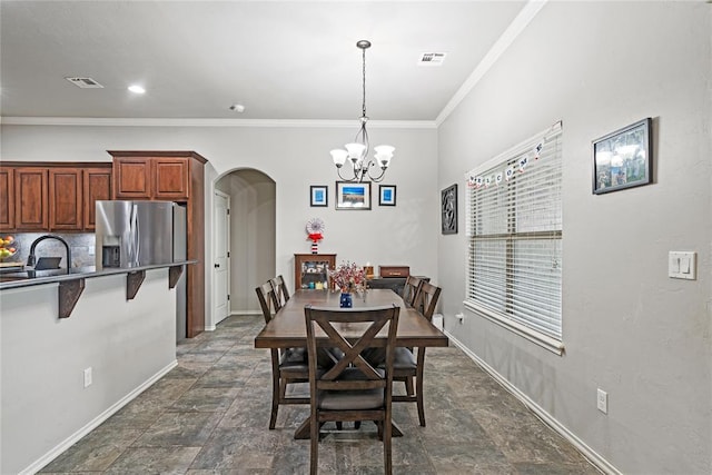 7324 Ridge Manor Ln, Oklahoma City, OK 73150 - dining space with arched walkways, dark stone finish floors, a chandelier, and ornamental molding