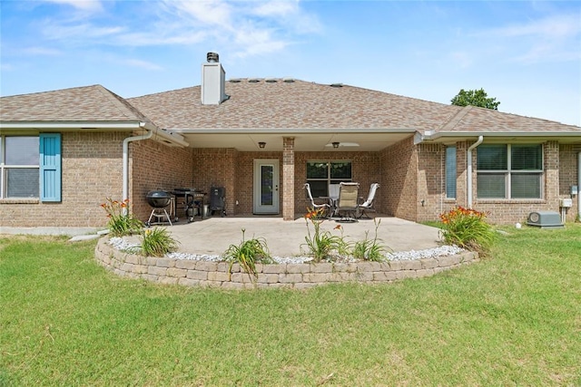 7324 Ridge Manor Ln, Oklahoma City, OK 73150 - rear view of house with a chimney, brick siding, and a lawn