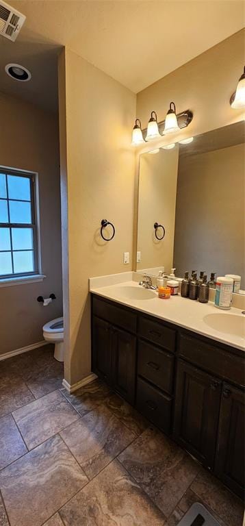 12201 Buckingham Ln, Yukon, OK 73099 - full bathroom with double vanity and stone finish floors