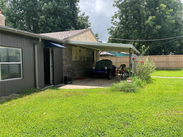 view of home's exterior with an attached carport, a chimney, and brick siding