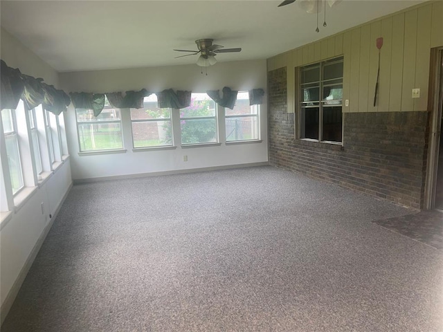 unfurnished sunroom featuring baseboards
