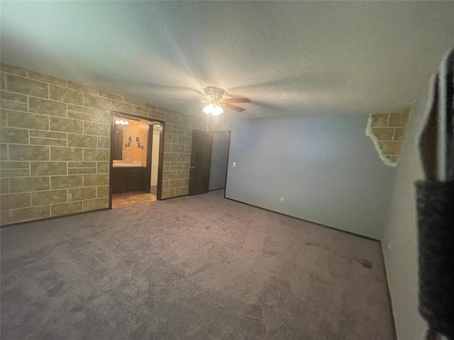 unfurnished bedroom featuring carpet, a ceiling fan, and a textured ceiling