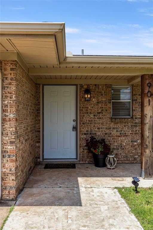 901 E Covell Rd, Edmond, OK 73034 - property entrance featuring brick siding