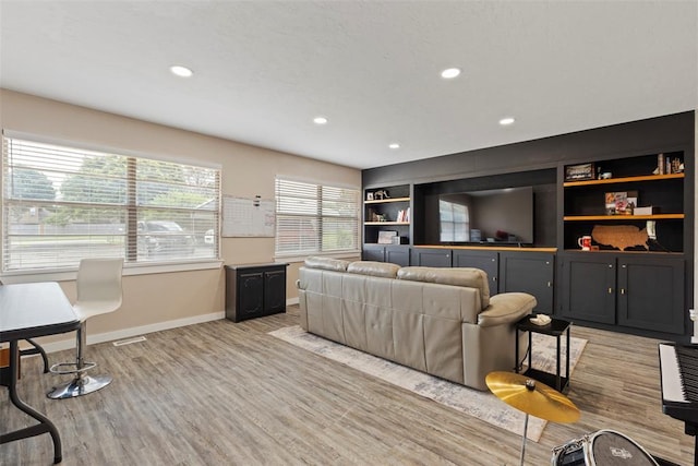901 E Covell Rd, Edmond, OK 73034 - living room featuring light wood-style flooring, recessed lighting, and built in shelves