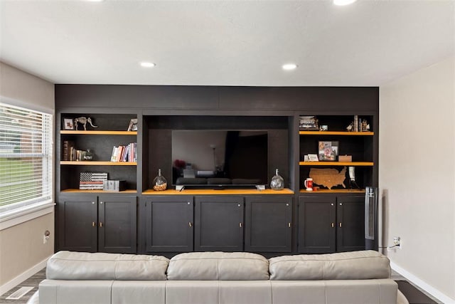 901 E Covell Rd, Edmond, OK 73034 - living area with wood finished floors, built in features, and recessed lighting