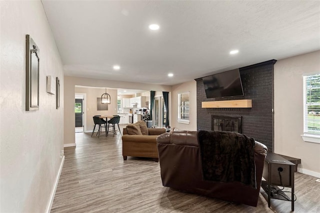 901 E Covell Rd, Edmond, OK 73034 - living area with light wood-style floors, a fireplace, and recessed lighting