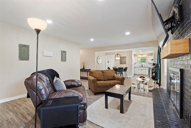 901 E Covell Rd, Edmond, OK 73034 - living area featuring wood finished floors, a fireplace, and recessed lighting