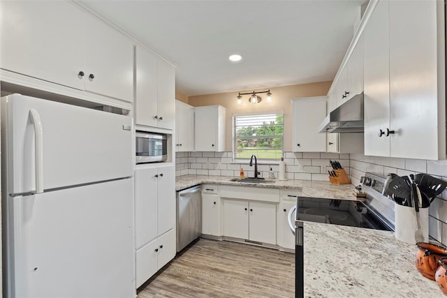 901 E Covell Rd, Edmond, OK 73034 - kitchen with appliances with stainless steel finishes, range hood, white cabinetry, decorative backsplash, and recessed lighting