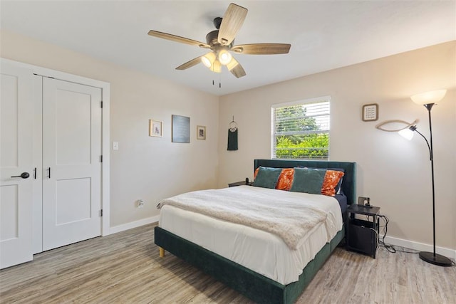 901 E Covell Rd, Edmond, OK 73034 - bedroom featuring wood finished floors and a ceiling fan