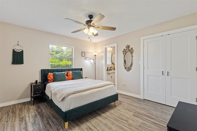 901 E Covell Rd, Edmond, OK 73034 - bedroom with wood finished floors, connected bathroom, and ceiling fan