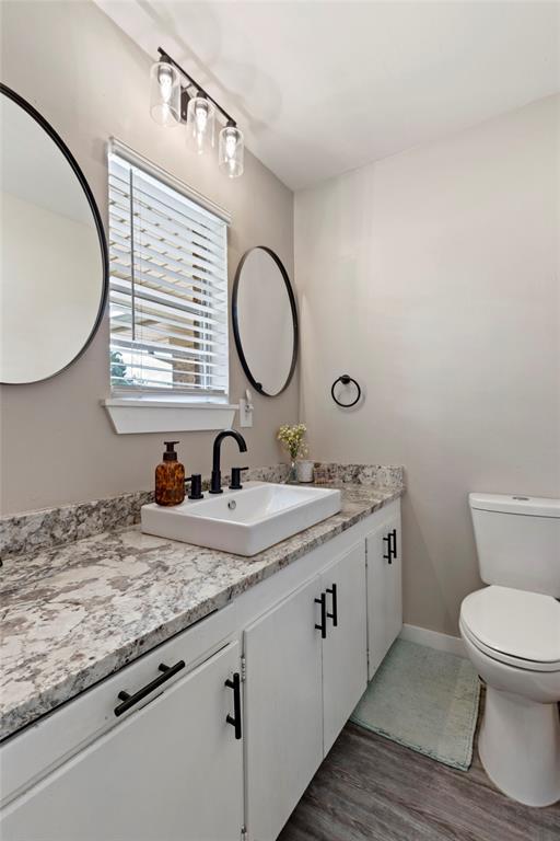 901 E Covell Rd, Edmond, OK 73034 - bathroom with vanity and wood finished floors