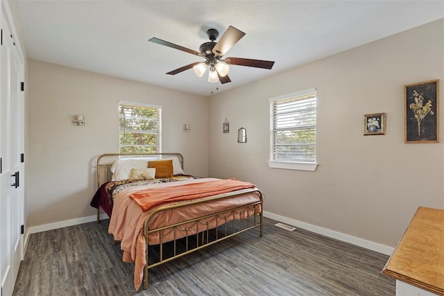 901 E Covell Rd, Edmond, OK 73034 - bedroom with dark wood-style floors and a ceiling fan