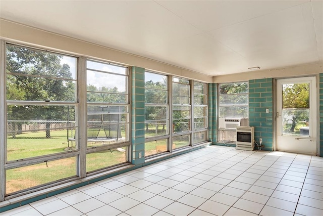 901 E Covell Rd, Edmond, OK 73034 - unfurnished sunroom with tile patterned floors and cooling unit
