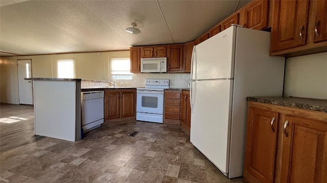 1500 S Pine Cir, Guthrie, OK 73044 - kitchen with white appliances, brown cabinets, and a peninsula