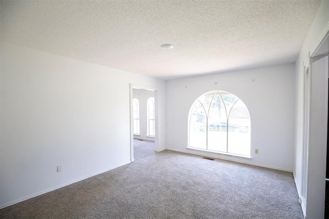 2328 NW 113th St, Oklahoma City, OK 73120 - empty room with carpet floors and a textured ceiling