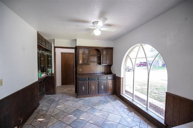 2328 NW 113th St, Oklahoma City, OK 73120 - unfurnished dining area featuring a ceiling fan and a textured ceiling