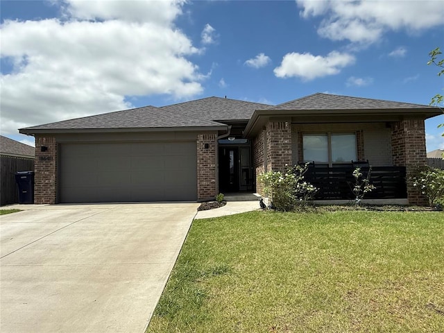 18641 Como Dr, Edmond, OK 73012 - prairie-style house featuring brick siding, driveway, a garage, and a front lawn