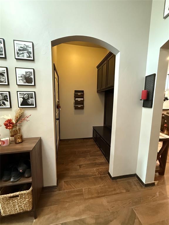18641 Como Dr, Edmond, OK 73012 - corridor with dark wood-style floors and arched walkways