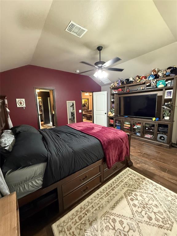 18641 Como Dr, Edmond, OK 73012 - bedroom featuring lofted ceiling, wood finished floors, and a ceiling fan