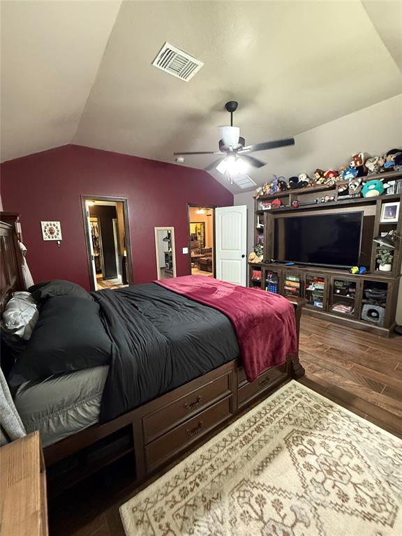 18641 Como Dr, Edmond, OK 73012 - bedroom featuring vaulted ceiling, wood finished floors, and ceiling fan