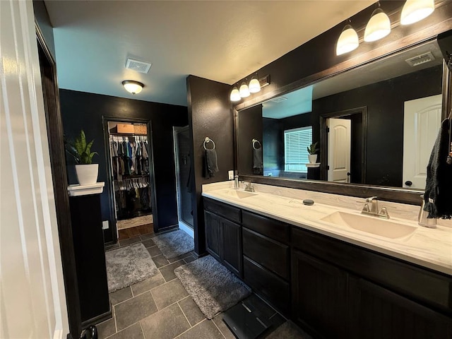18641 Como Dr, Edmond, OK 73012 - full bathroom with double vanity, a walk in closet, and a shower